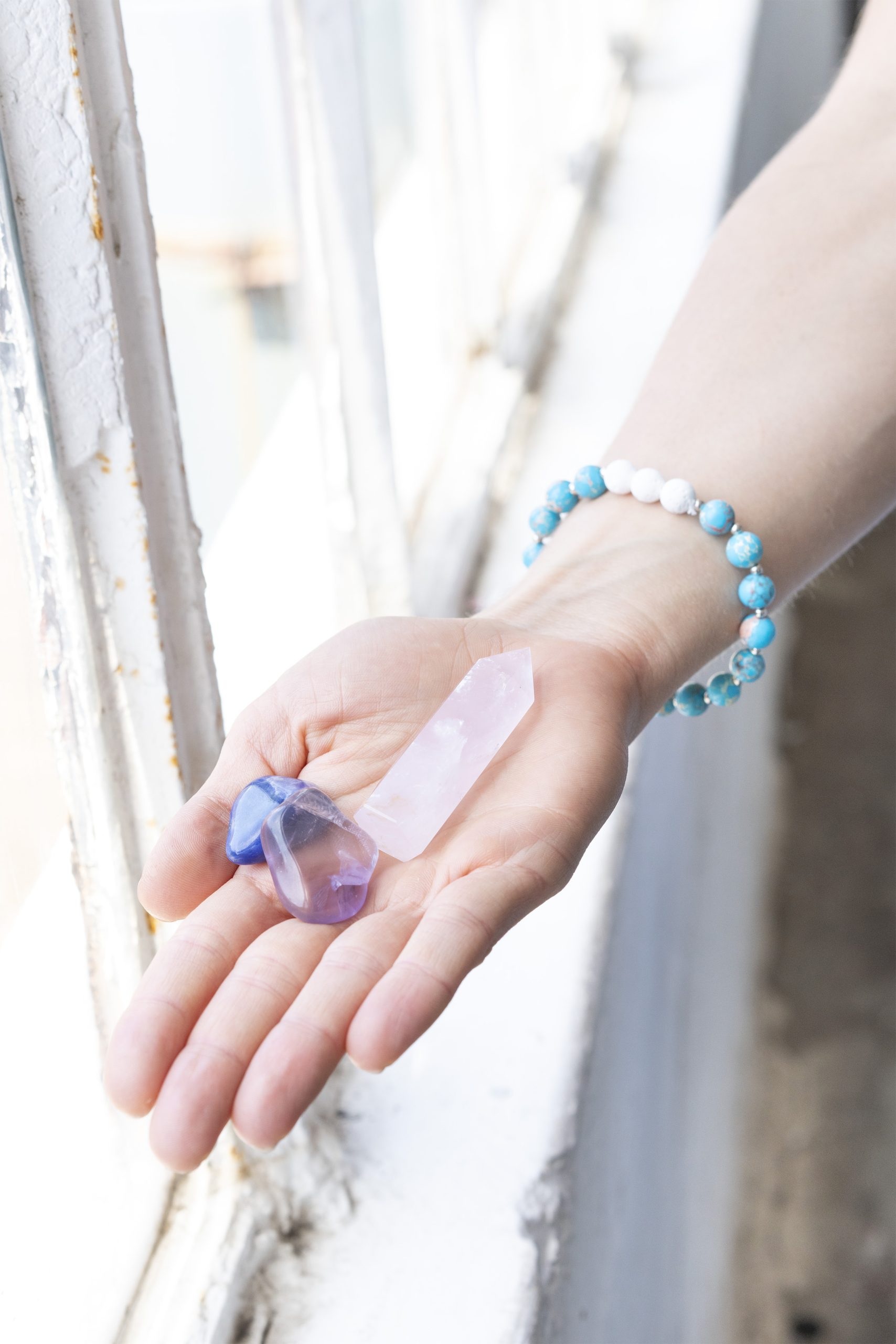 healing crystals in the palm of a hand - soulpreneur